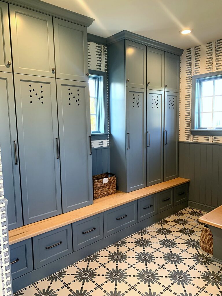 Custom mudroom locker wall with bench seat serving as an after-school drop zone