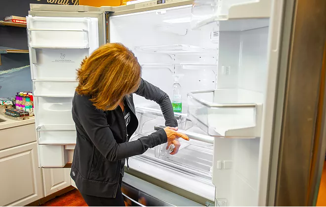 Wipe down the fridge with warm water and soap