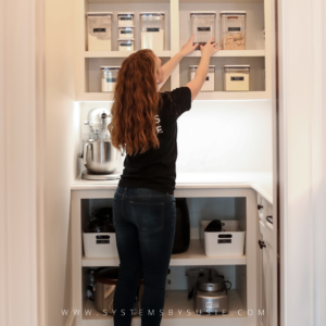 professional organizer adjusts canisters in pantry