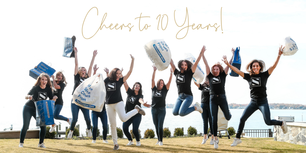 Systems by Susie Team Jumping in Celebration with bags from the Container Store