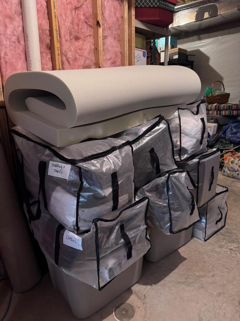 Mattress topper on top of moving bags for dorm move-in