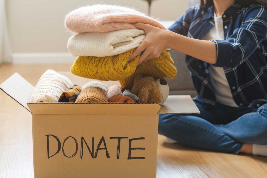 Box of clothing ready to donate after decluttering
