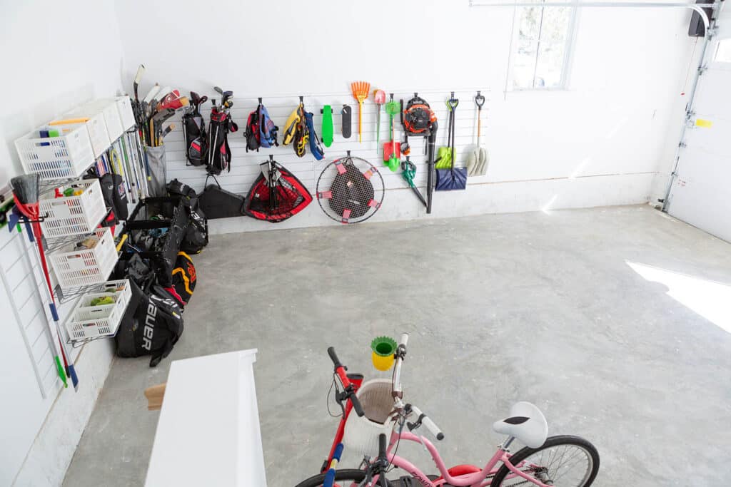 Track systems and hooks can help get things off the floor for an organized garage