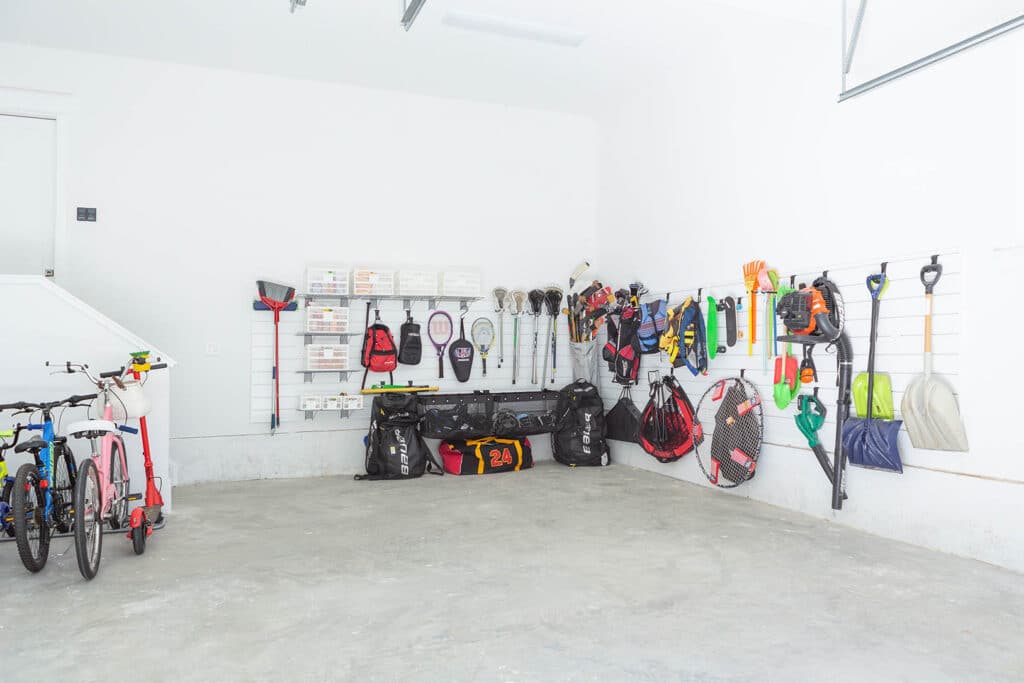 Track systems and hooks can help get things off the floor for an organized garage