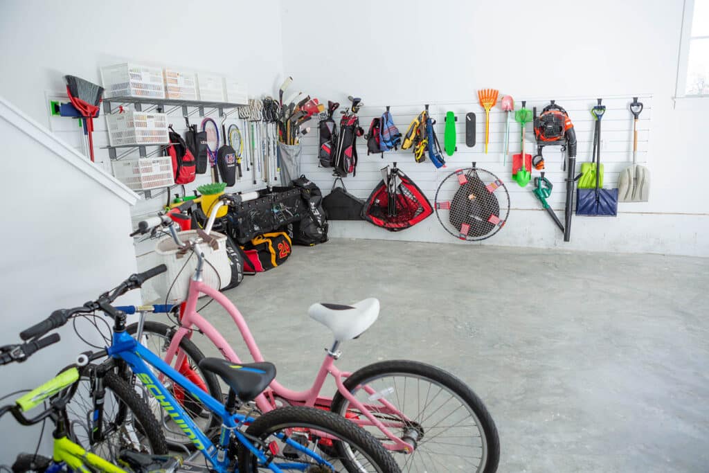 Track systems and hooks can help get things off the floor for an organized garage