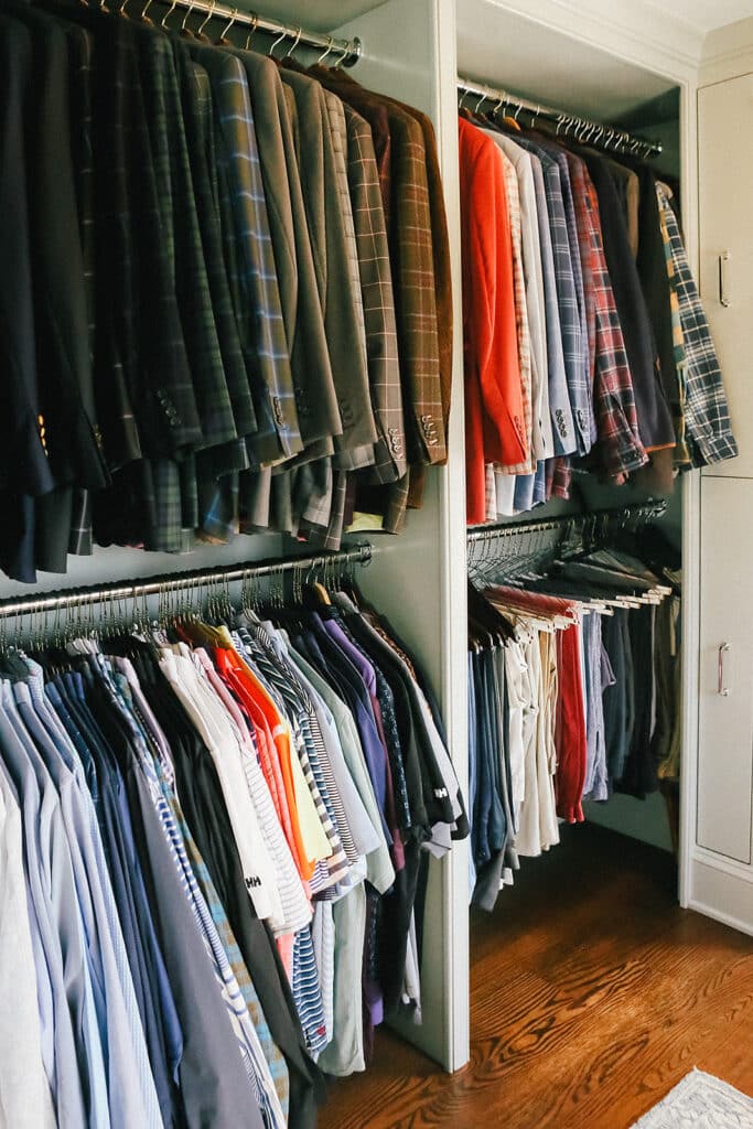 Clothing hanging in a closet with matching hangers.