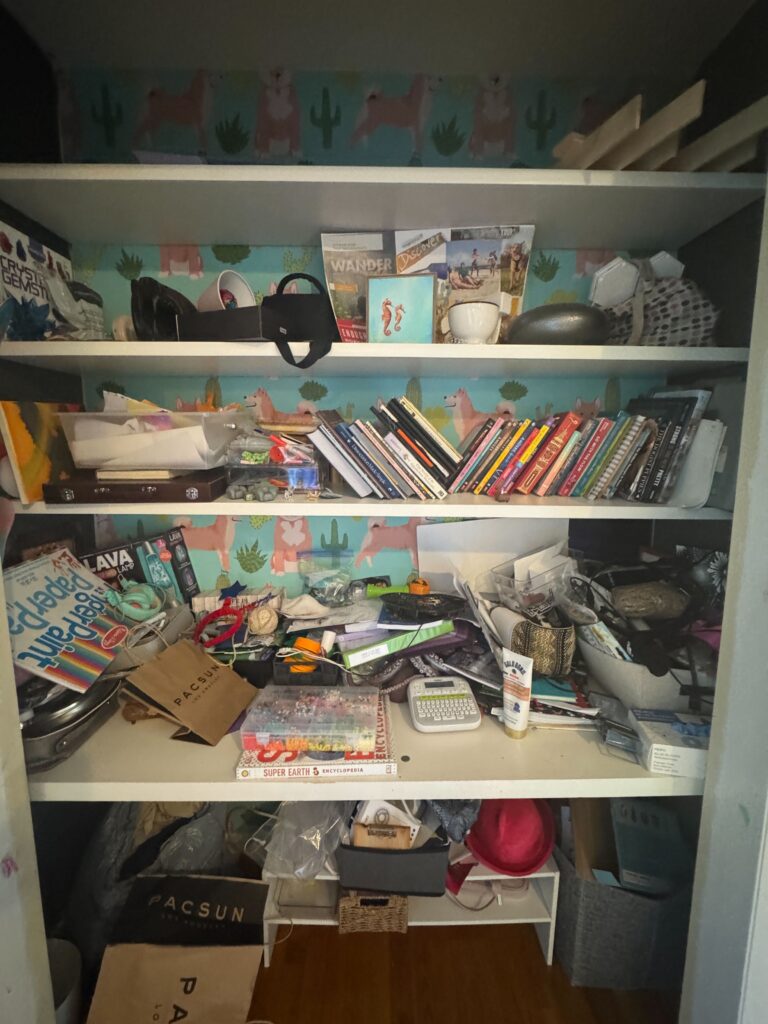 A messy closet with a desk