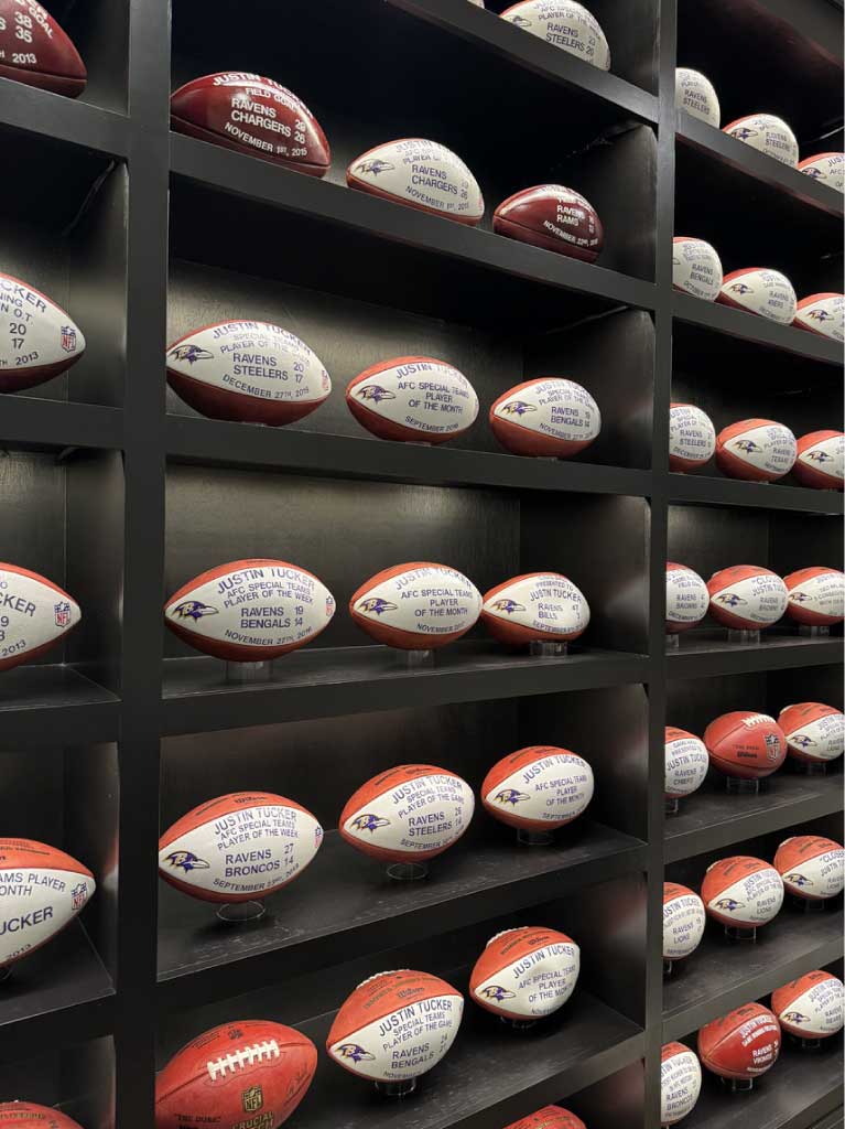 Wall with signed footballs from a sports relocation project