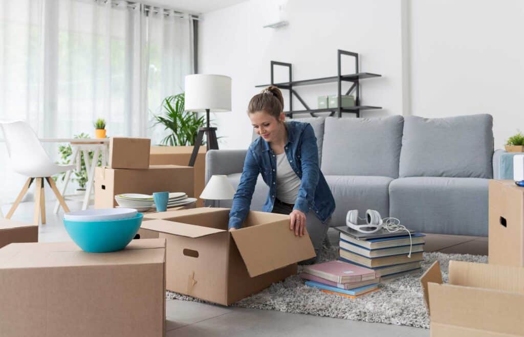 Woman unpacking boxes after moving