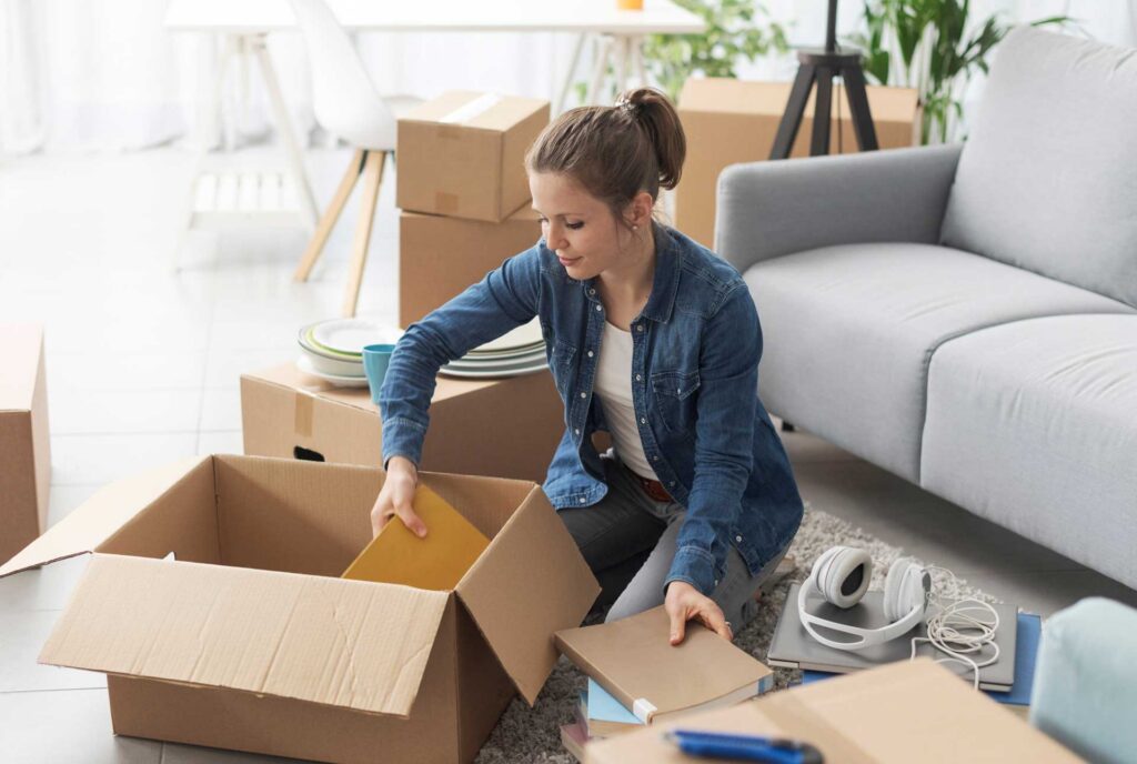 Woman unpacking a box with some folders after moving