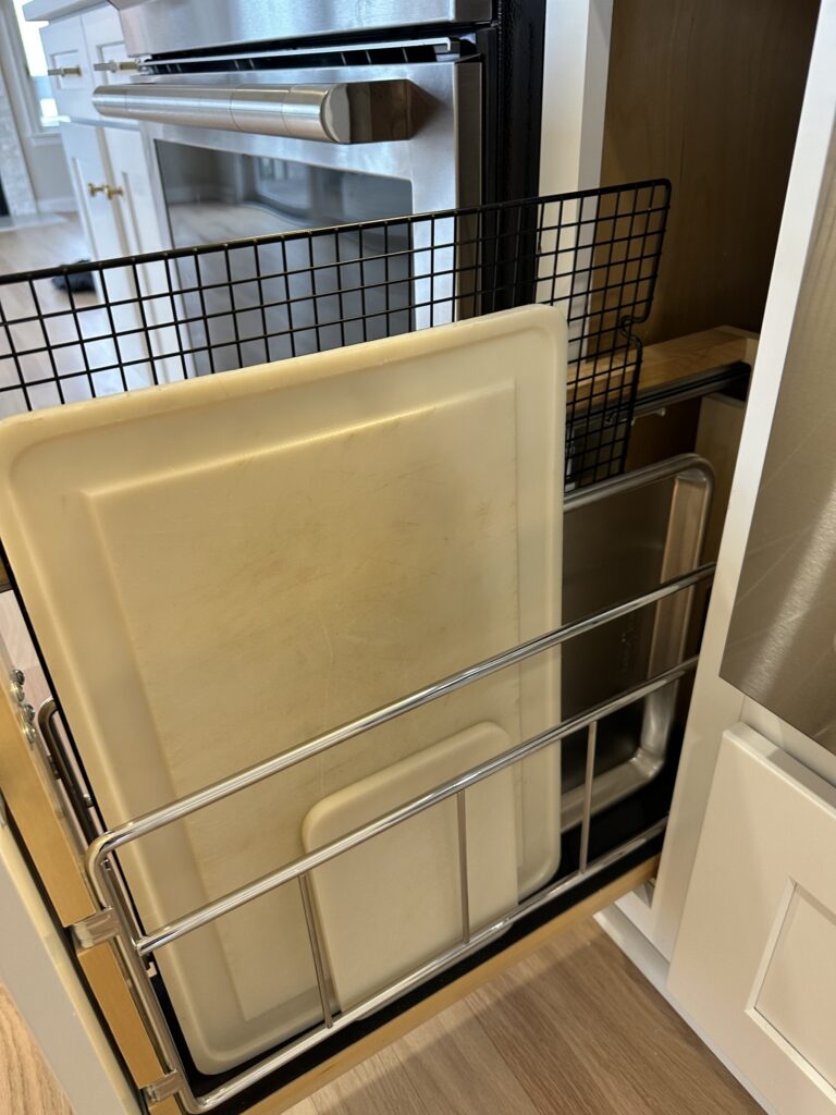 Narrow cabinet for bakeware next to stove
