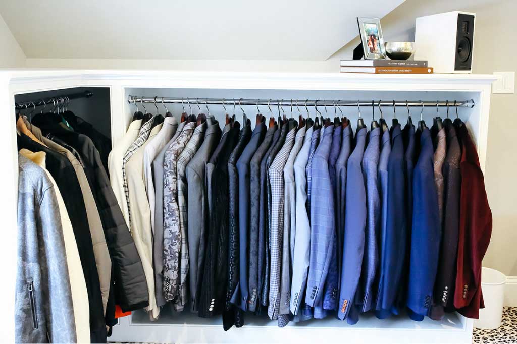 Suits organized in a closet