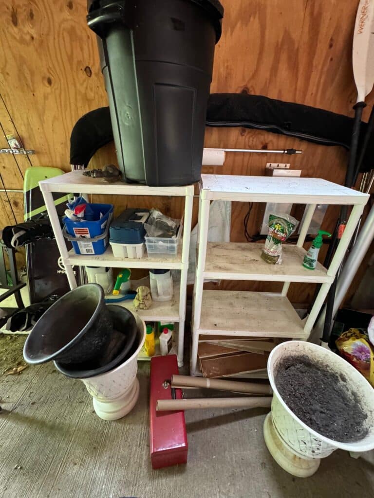 Disorganized shed shelving units packed with outdoor items before professional home organization
