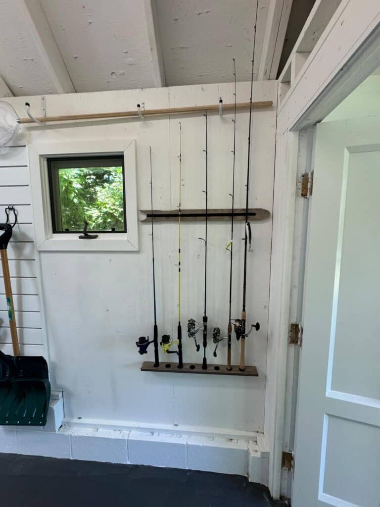 Vertical fishing rod organizer mounted on the wall of an organized Annapolis backyard shed