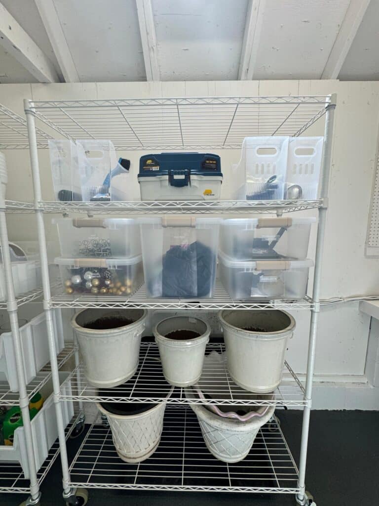 White rolling wire shelving with clear bins for organized outdoor storage in Annapolis backyard shed