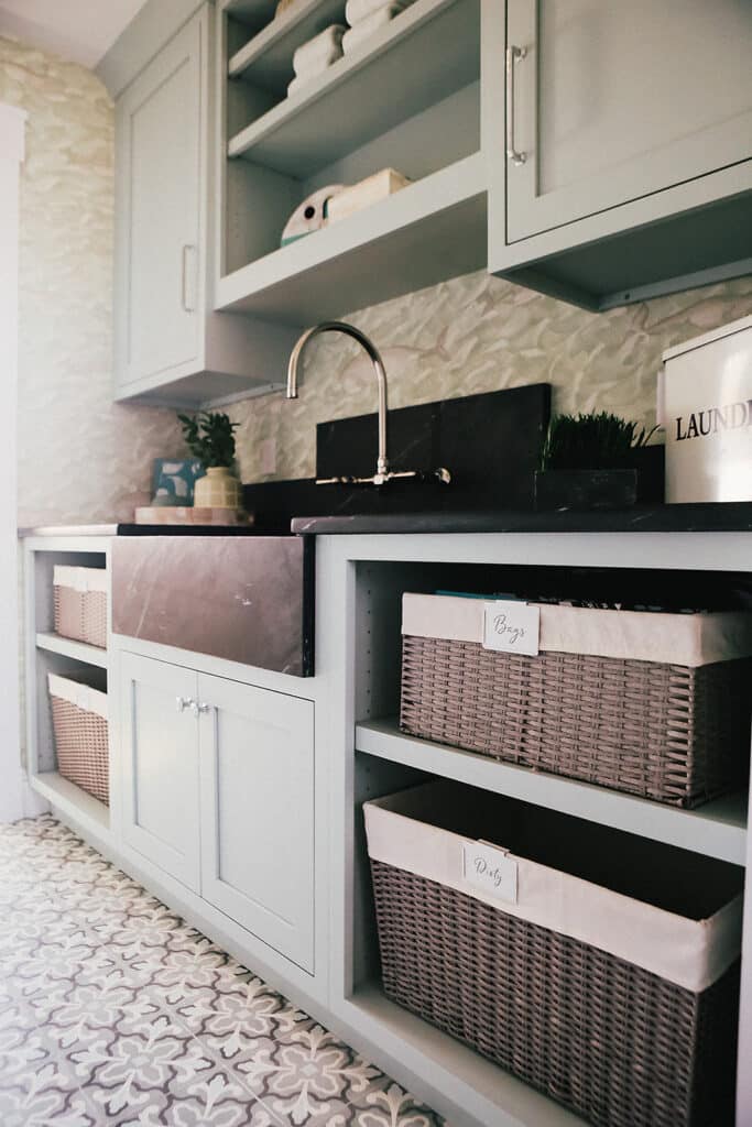Laundry room sink, cabinets, counter, and shelves