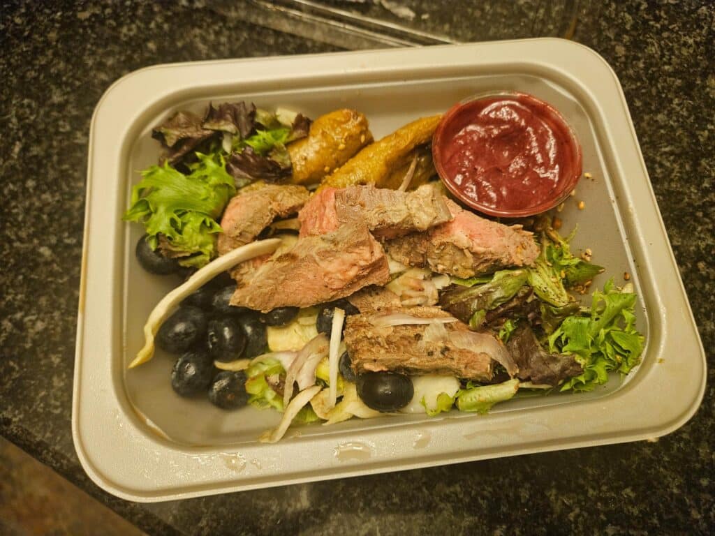 Mixed greens salad with flat iron steak