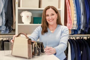 Susie is organizing purses in a beautifully organized closet